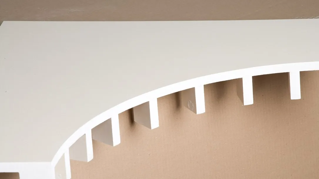 Curved Caesarstone quartz surface with precision-cut slots prepared for thermoforming.