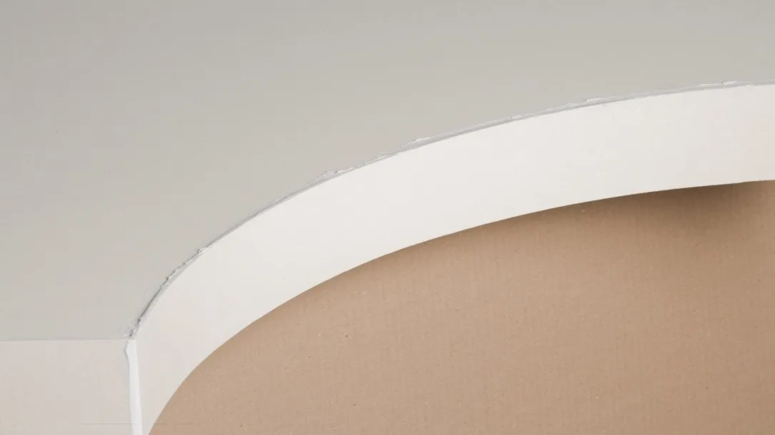 Close-up of a Caesarstone thermoformed quartz surface showing a curved edge before final finishing.