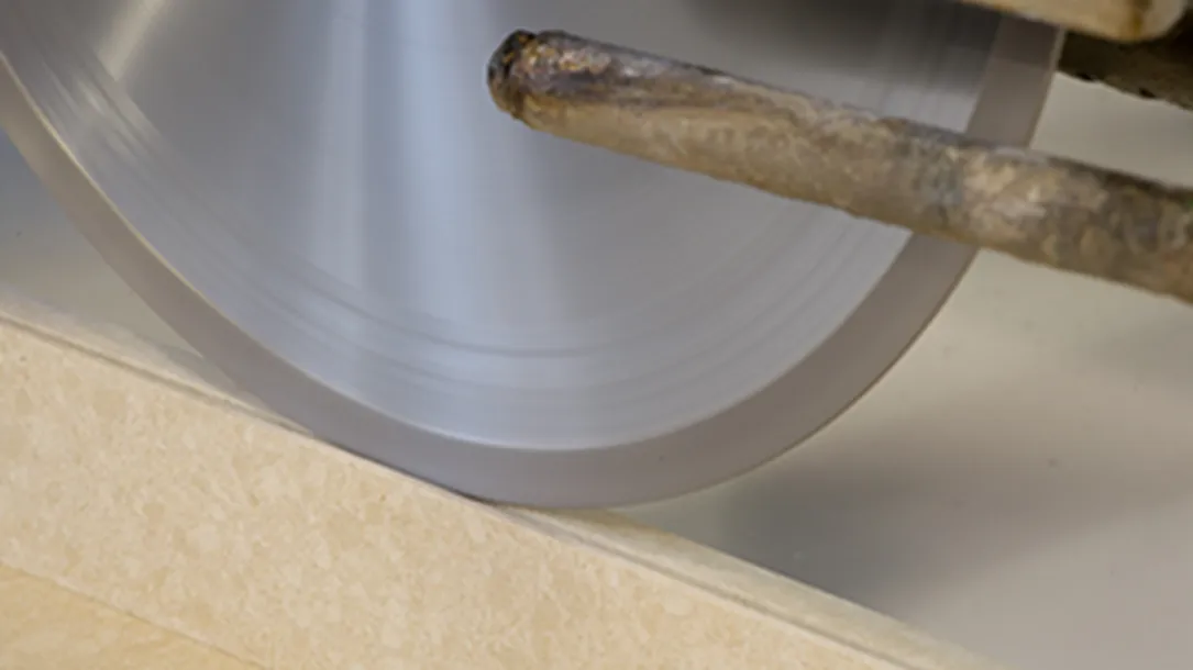 Close-up of a diamond saw cutting a quartz slab during fabrication.